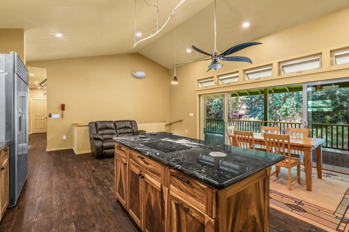 5011 Awawa Road Kalaheo, HI 96741 - Photo 3 of 30 a kitchen that has a stove and a table in it