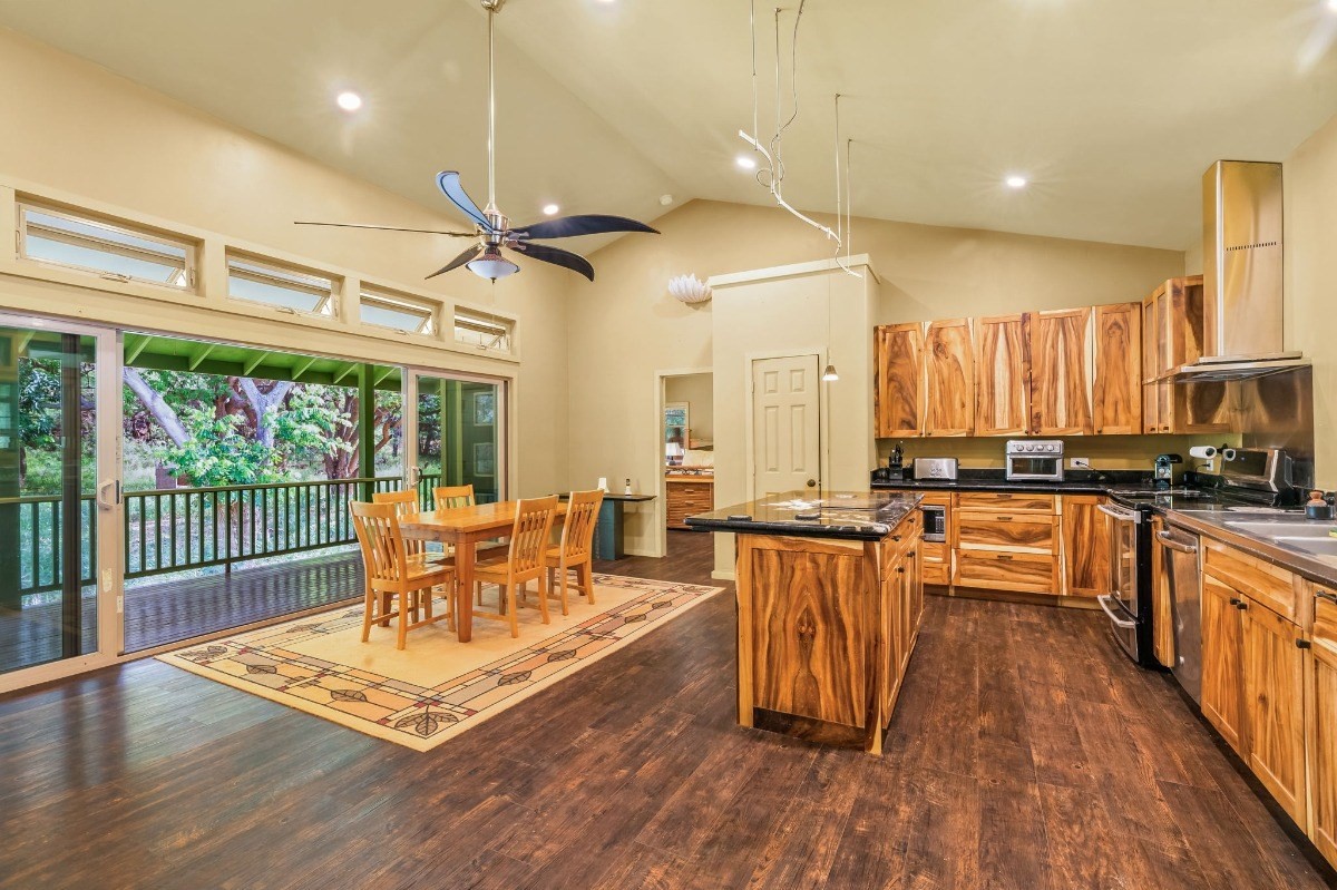 5011 Awawa Road Kalaheo, HI 96741 - Photo 4 of 30 a view of a kitchen with dining table and wooden floor