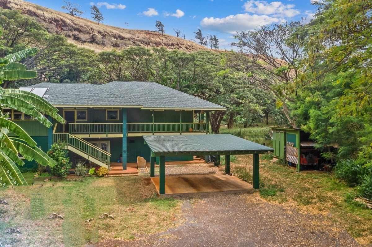 5011 Awawa Road Kalaheo, HI 96741 - Photo 8 of 30 a backyard of a house with table and chairs