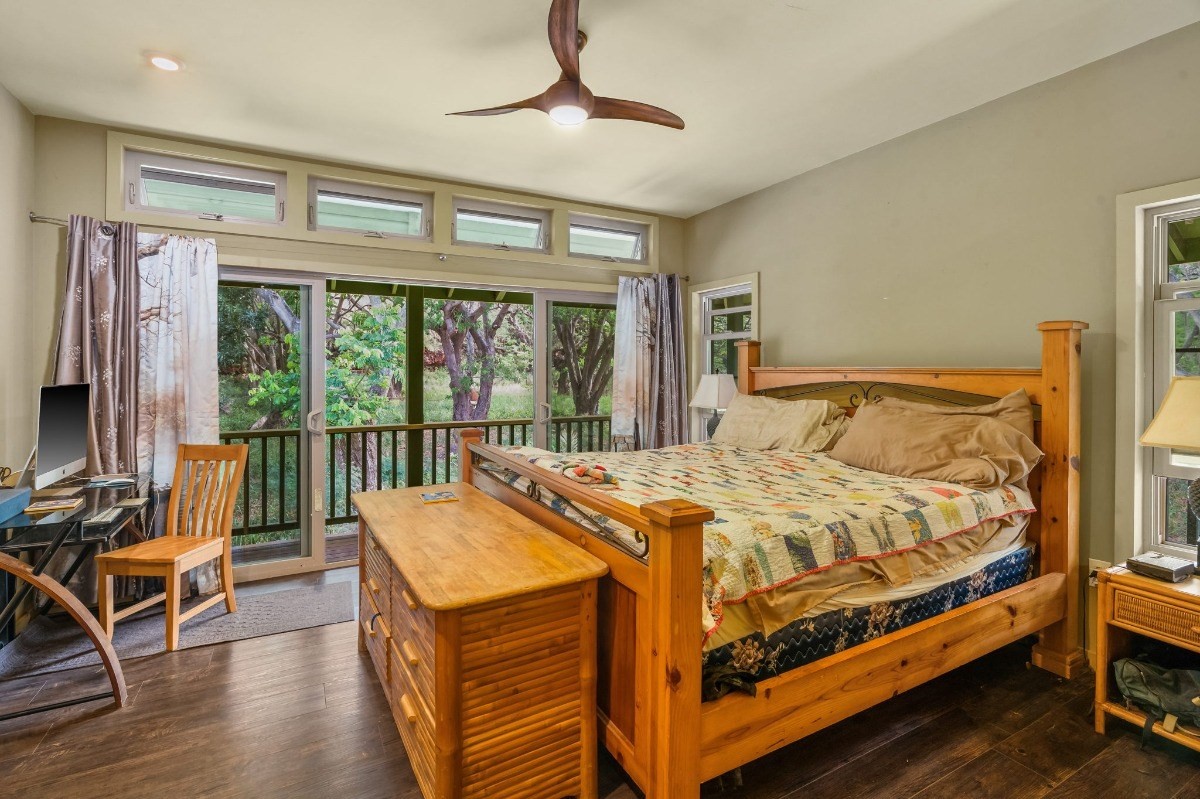 5011 Awawa Road Kalaheo, HI 96741 - Photo 10 of 30 a bed sitting in a bedroom next to a window