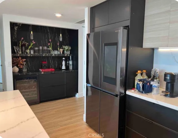 a kitchen with refrigerator and cabinets