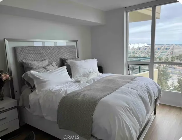 a bedroom with a bed and a large window