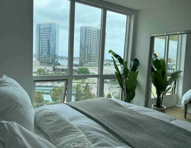 a bedroom with a large bed and a large window