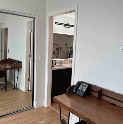 a view of a hallway with furniture and wooden floor