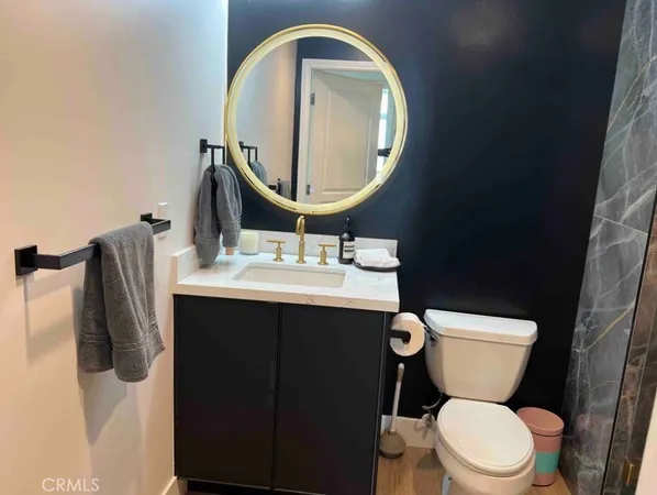 a bathroom with a sink mirror and toilet