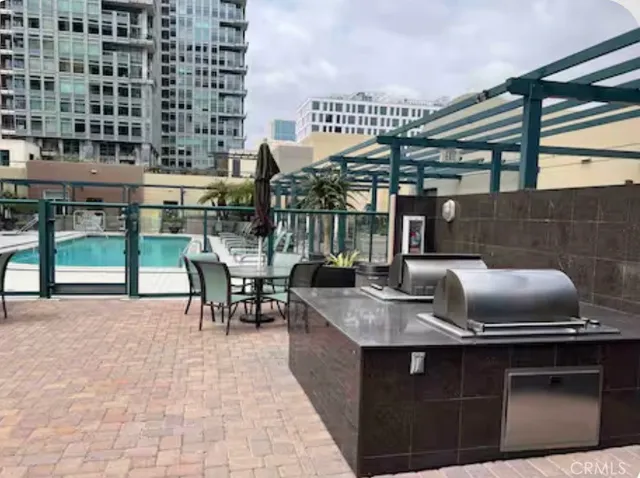a kitchen with a sink a stove and chairs
