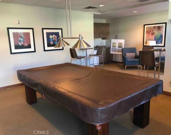 a room with furniture pool table and windows