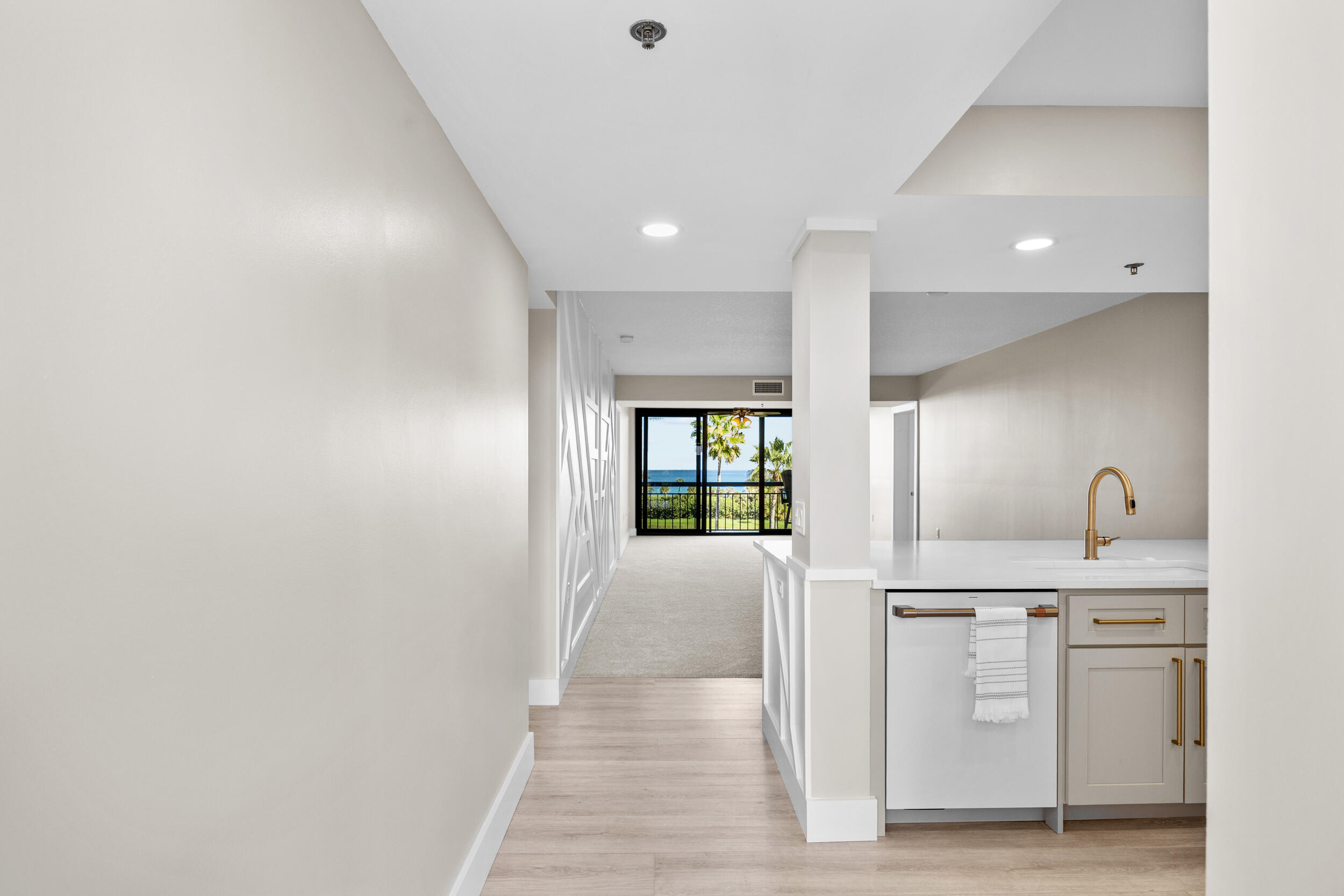 401 South Seas Drive, Unit 505 Jupiter, FL 33477 - Photo 13 of 39 a hallway with a sink and a window