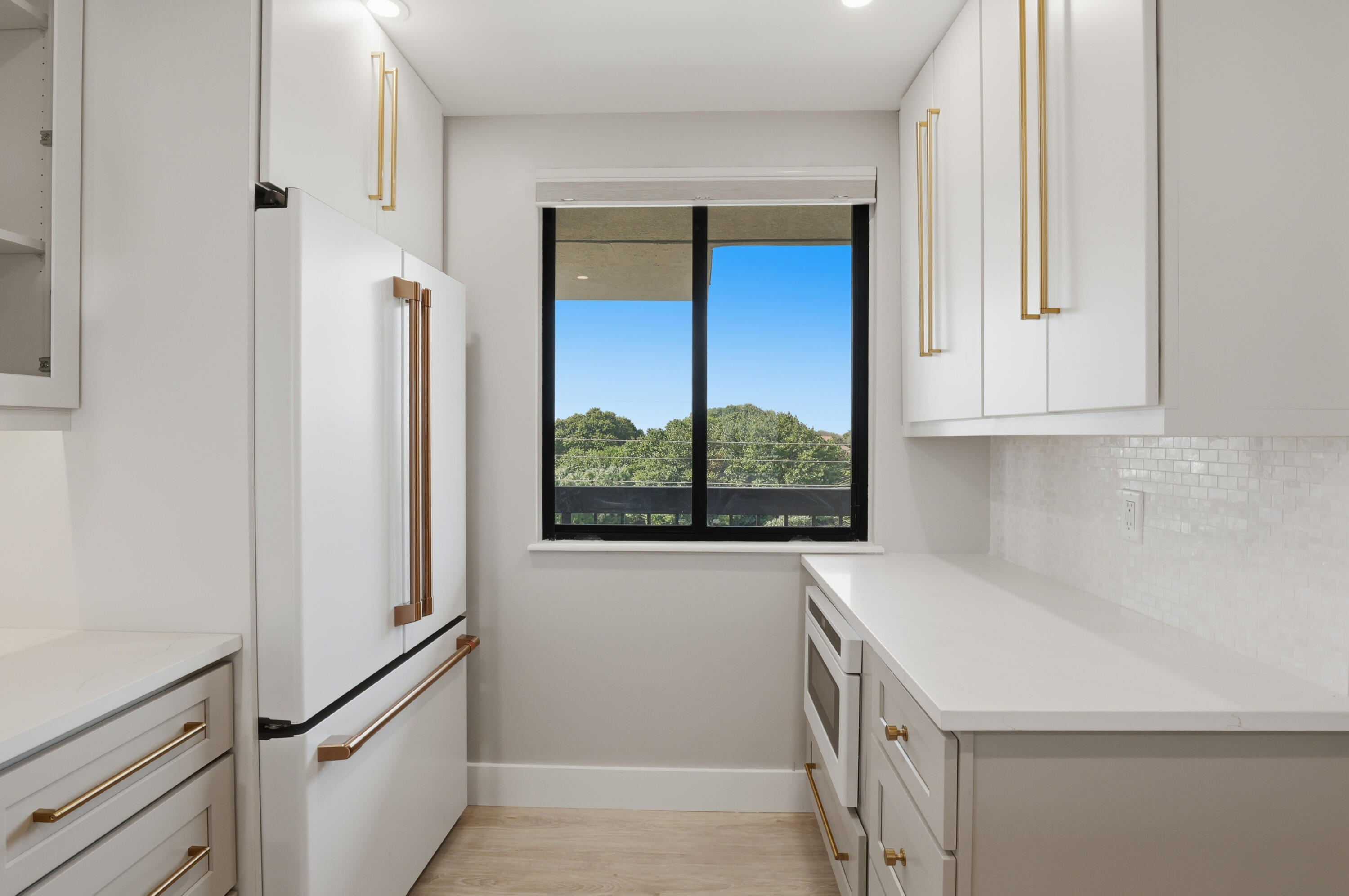 401 South Seas Drive, Unit 505 Jupiter, FL 33477 - Photo 18 of 39 a kitchen with stainless steel appliances a refrigerator and a window
