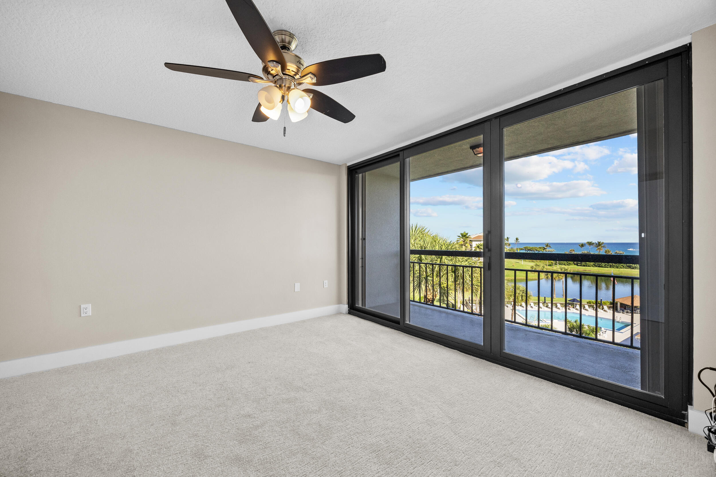 401 South Seas Drive, Unit 505 Jupiter, FL 33477 - Photo 24 of 39 an empty room with chandelier fan