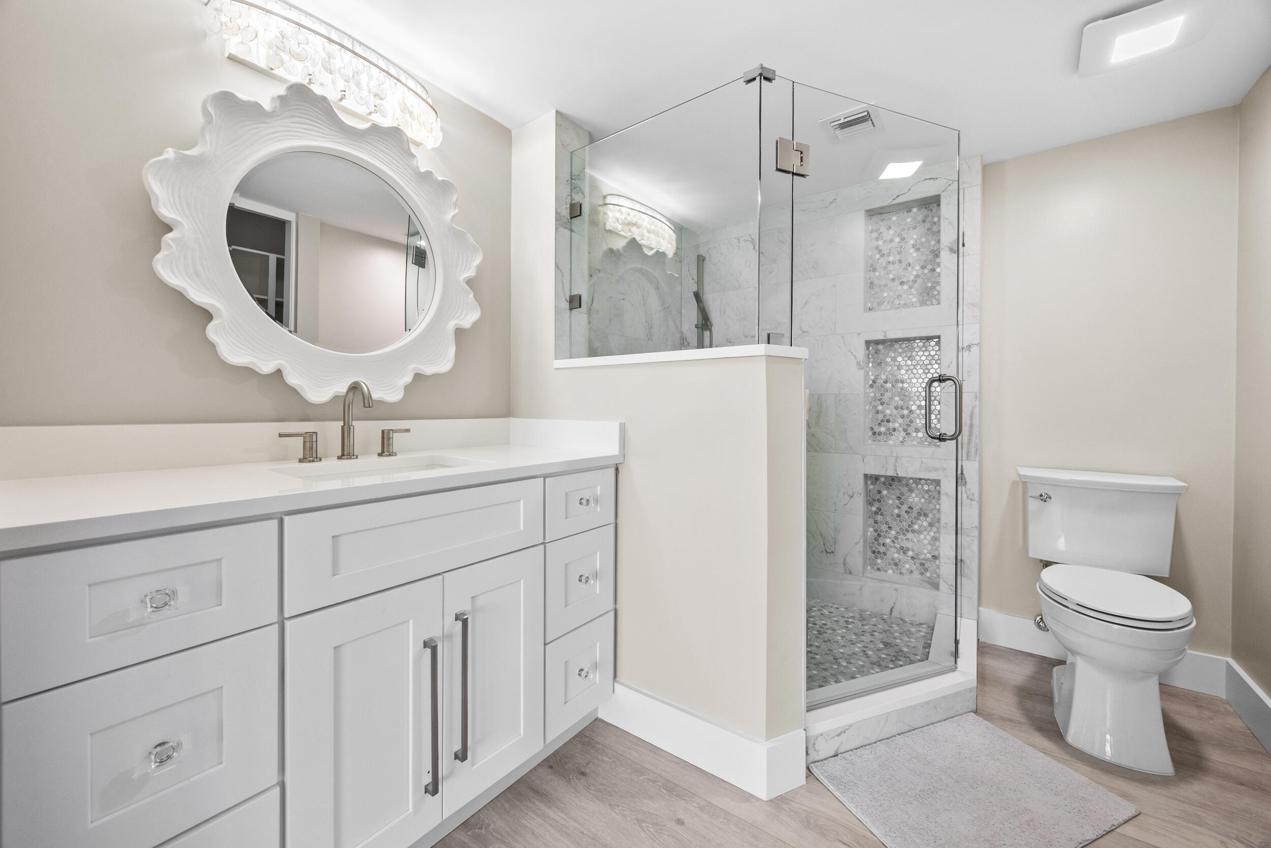 401 South Seas Drive, Unit 505 Jupiter, FL 33477 - Photo 25 of 39 a bathroom with a toilet sink and mirror