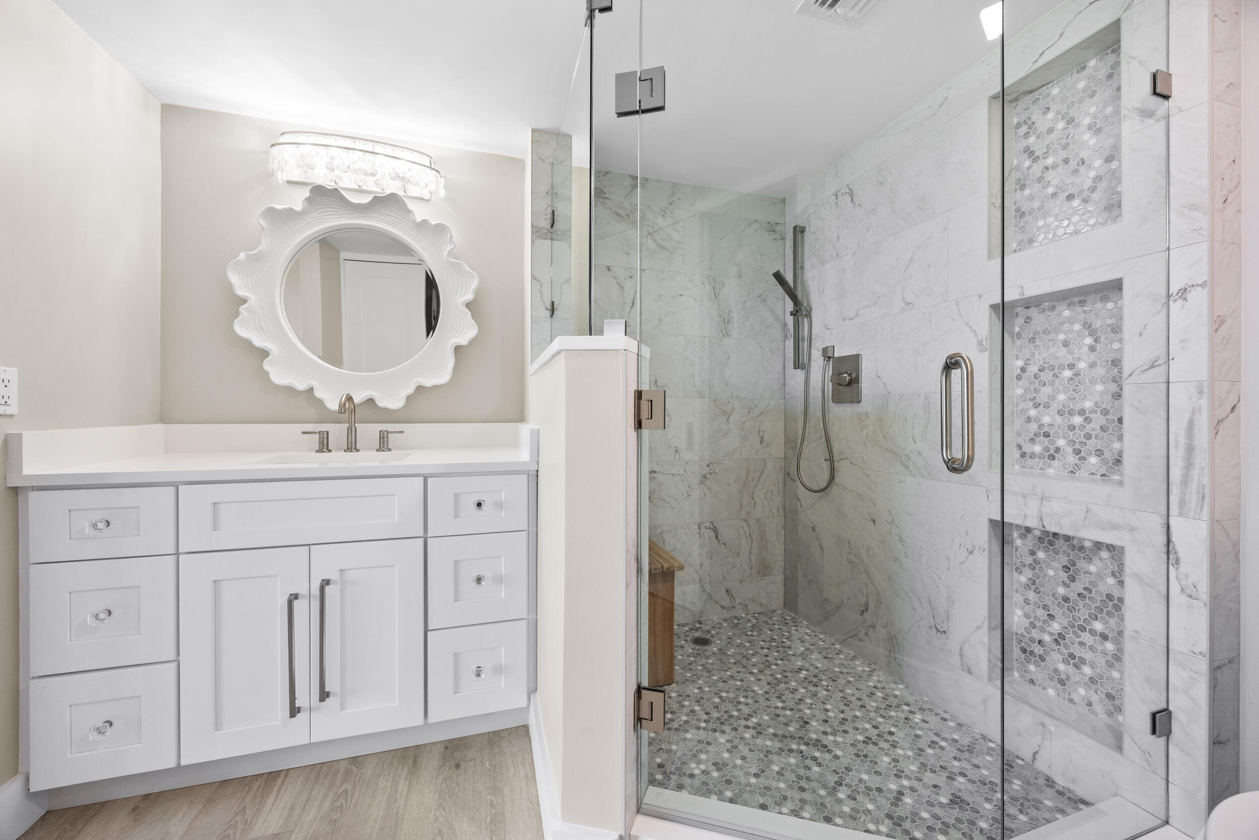 401 South Seas Drive, Unit 505 Jupiter, FL 33477 - Photo 26 of 39 a bathroom with a shower sink and mirror