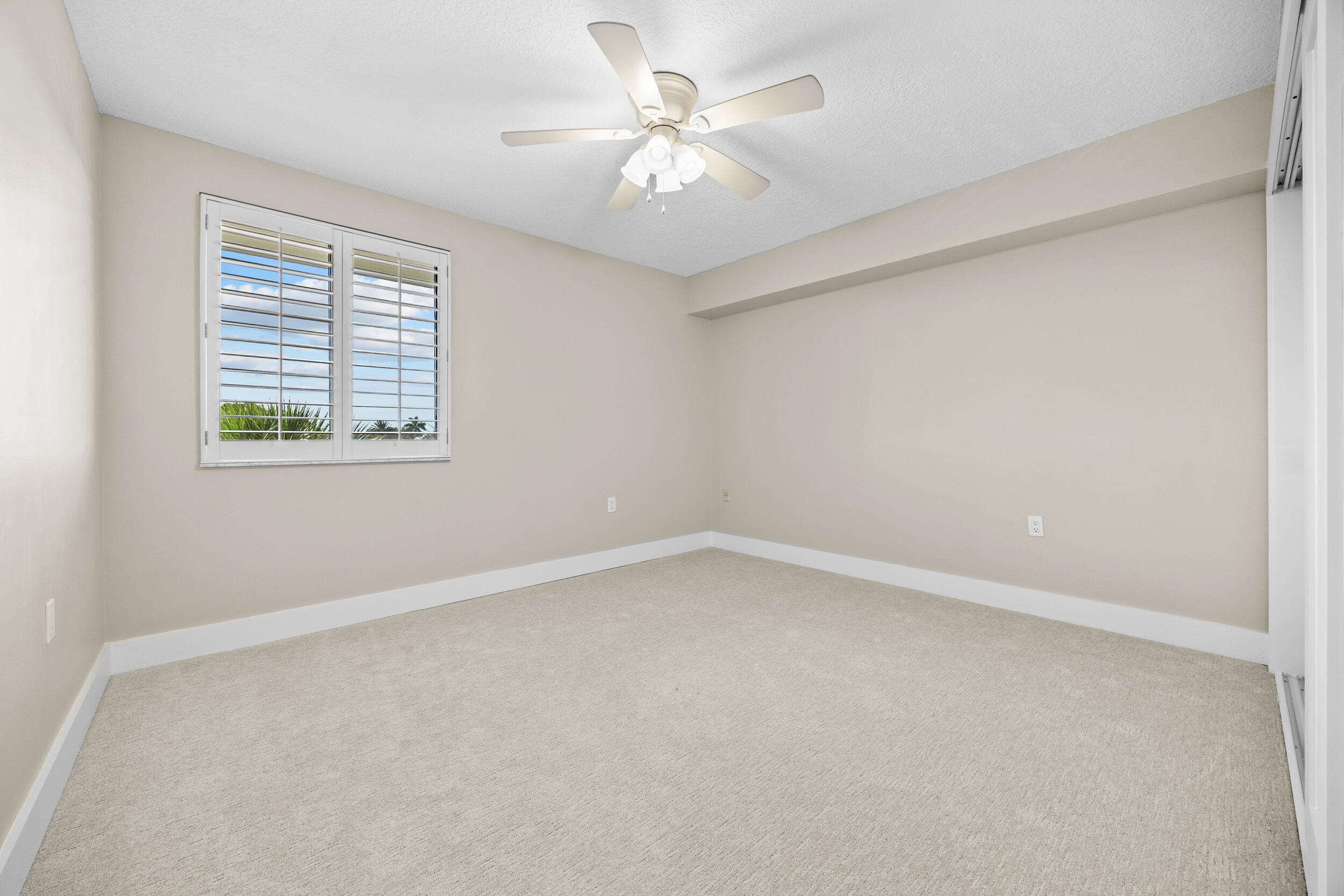 401 South Seas Drive, Unit 505 Jupiter, FL 33477 - Photo 27 of 39 an empty room with a window and a ceiling fan