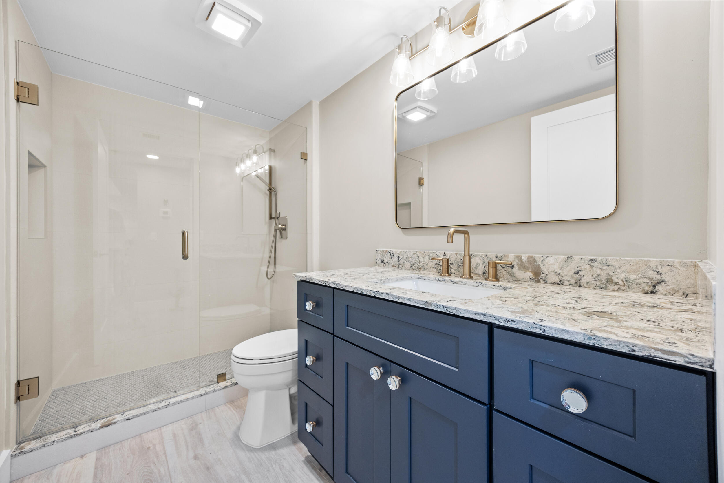 401 South Seas Drive, Unit 505 Jupiter, FL 33477 - Photo 29 of 39 a bathroom with a granite countertop sink a toilet and a mirror
