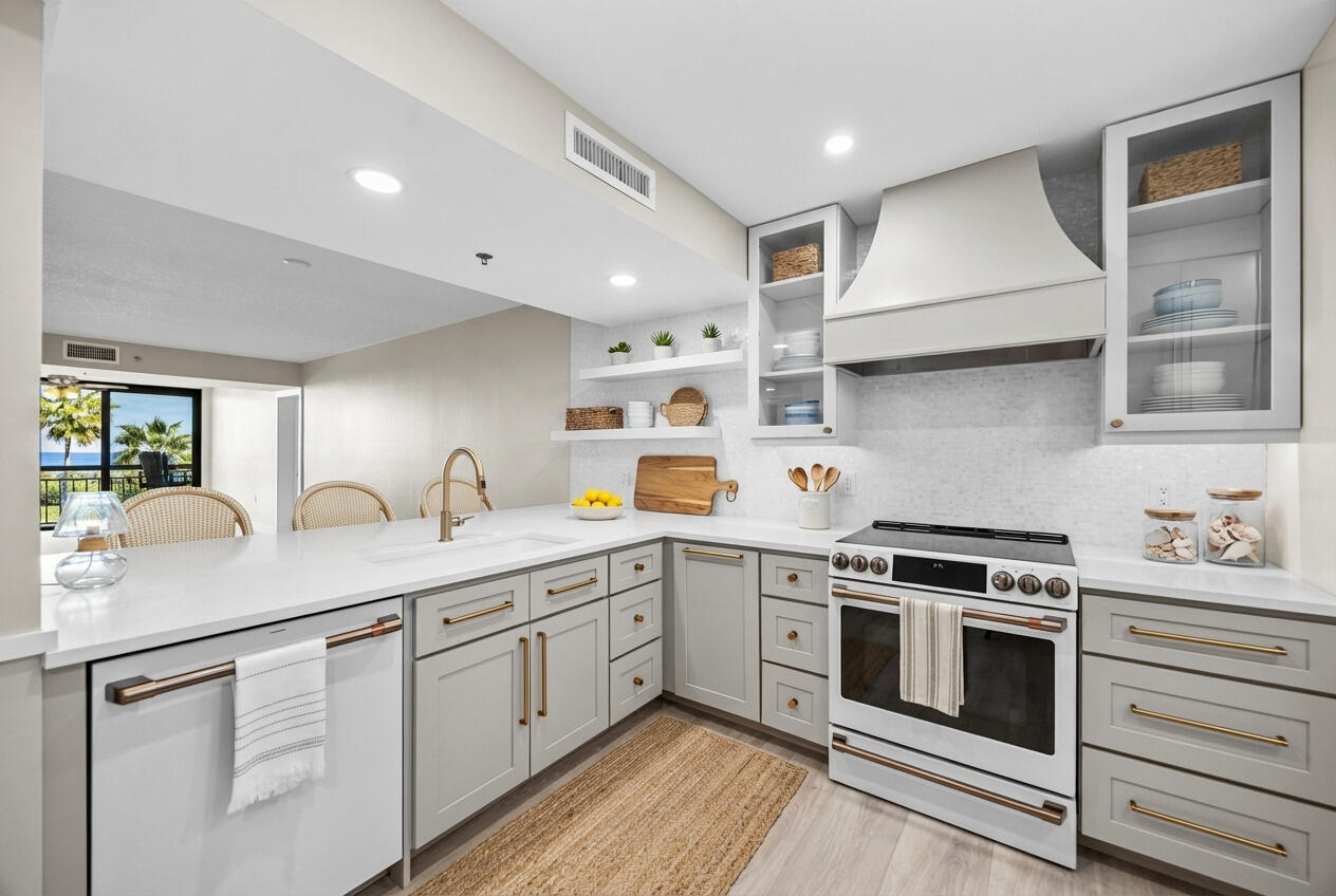 401 South Seas Drive, Unit 505 Jupiter, FL 33477 - Photo 3 of 39 a kitchen with a sink stove and cabinets