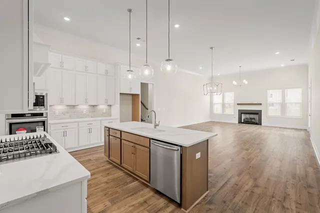 a kitchen with a stove a sink and a refrigerator