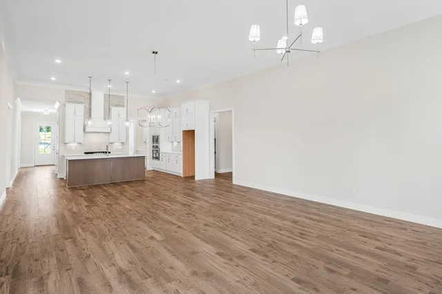 a view of kitchen and hall with wooden floor