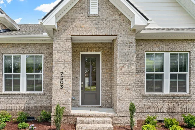 a front view of a brick house with a window