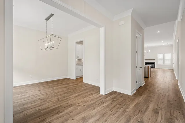 a view of a room with wooden floor and window