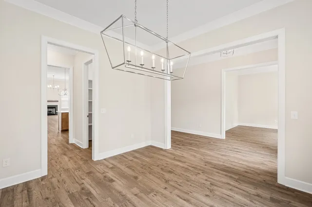 a view of a room with wooden floor