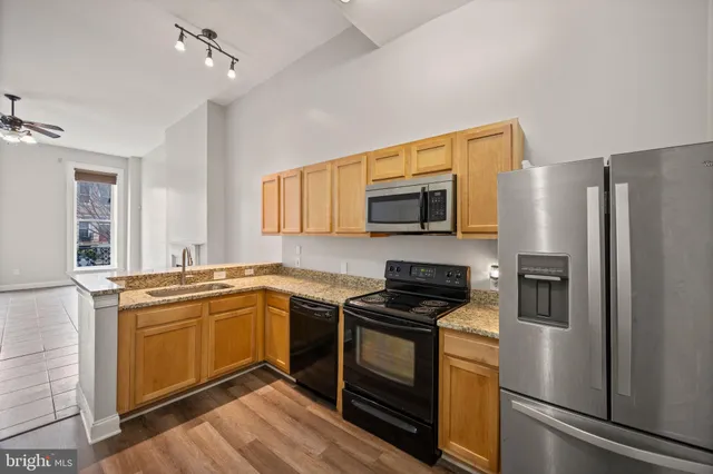a kitchen with stainless steel appliances granite countertop a stove microwave and refrigerator