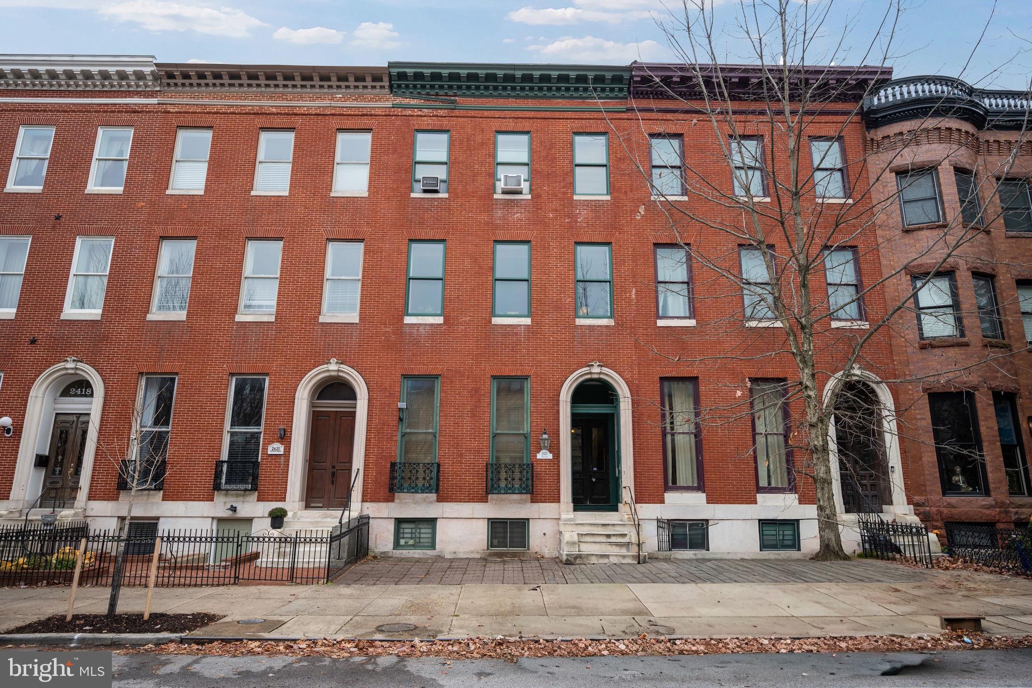 2422 Madison Avenue, Unit 1 Baltimore, MD 21217 - Photo 2 of 34 a front view of a building with garage
