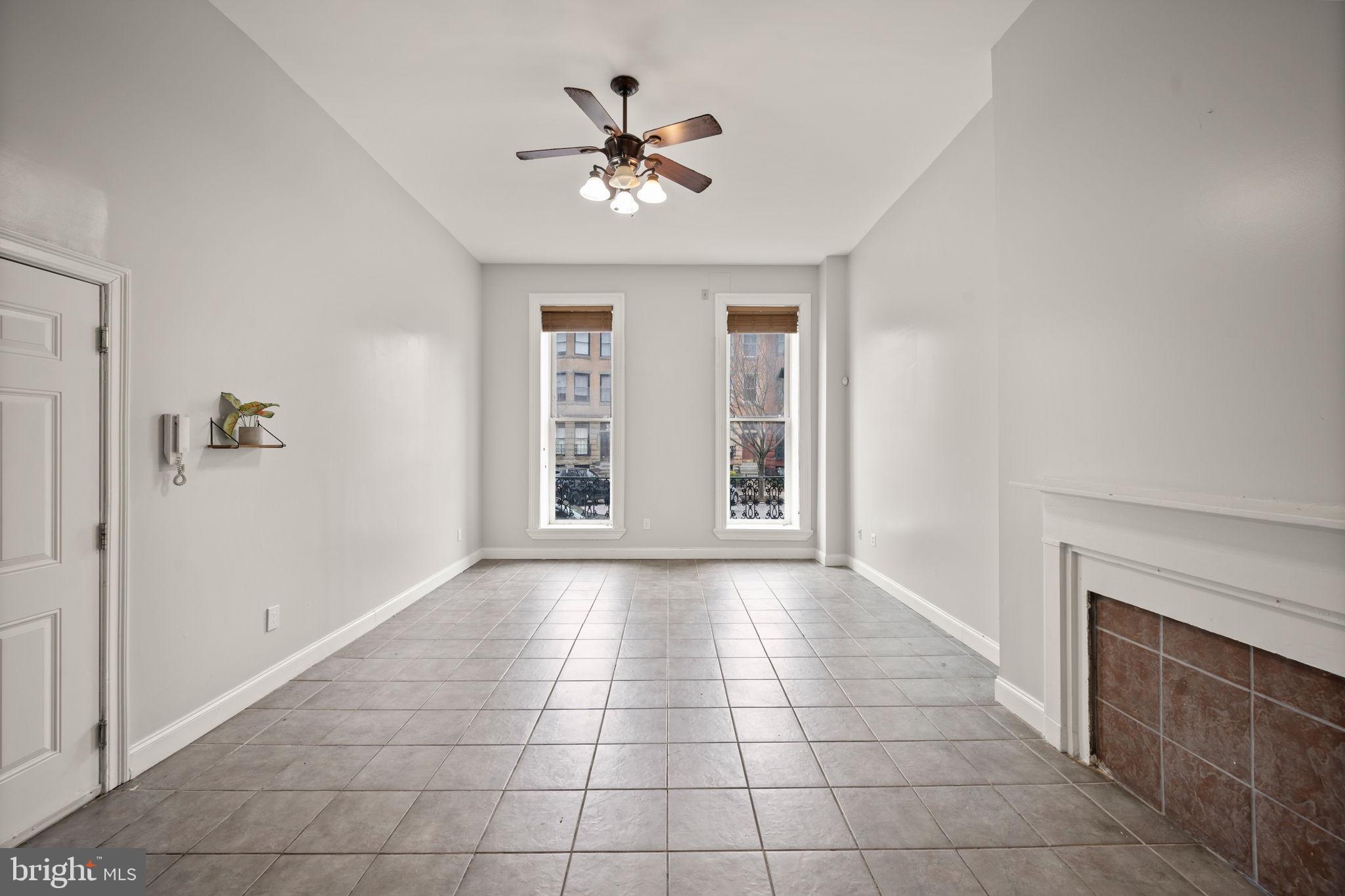2422 Madison Avenue, Unit 1 Baltimore, MD 21217 - Photo 23 of 34 a view of an empty room with chandelier fan and fire place