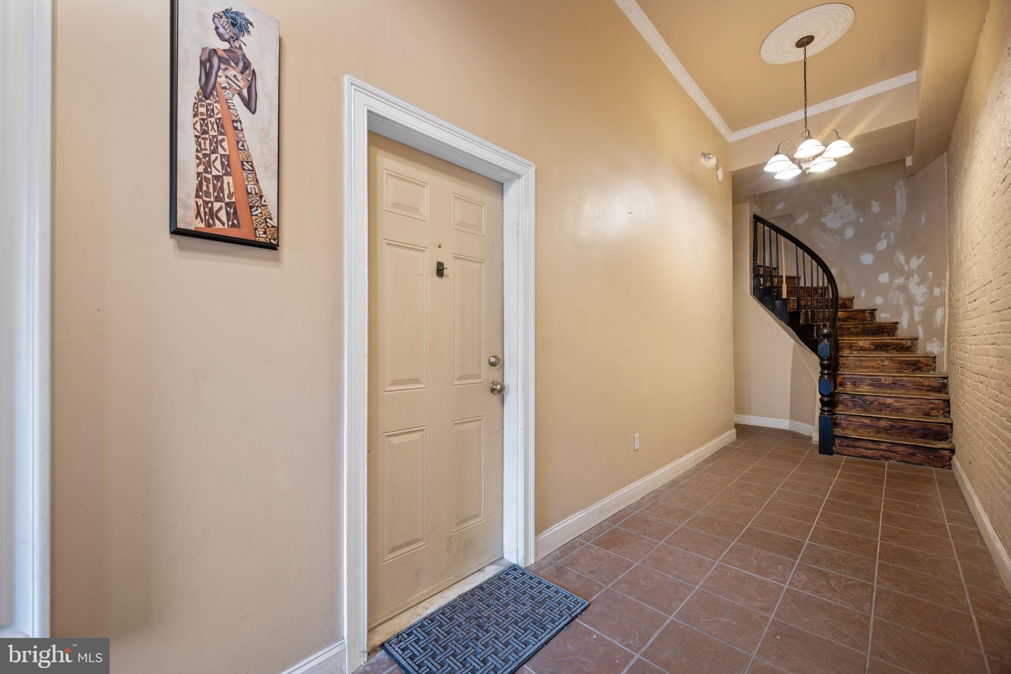 2422 Madison Avenue, Unit 1 Baltimore, MD 21217 - Photo 24 of 34 a view of hallway with stairs and a chandelier