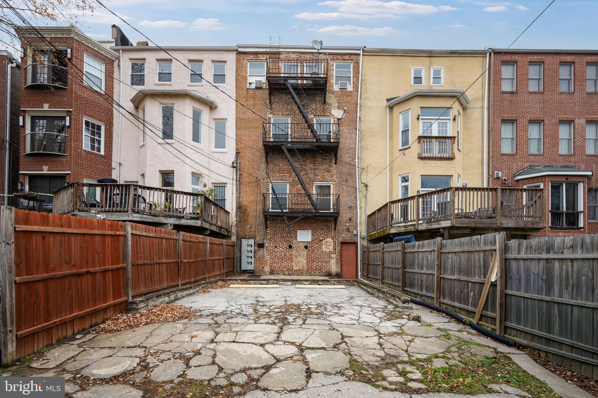 2422 Madison Avenue, Unit 1 Baltimore, MD 21217 - Photo 31 of 34 a front view of a house with parking area