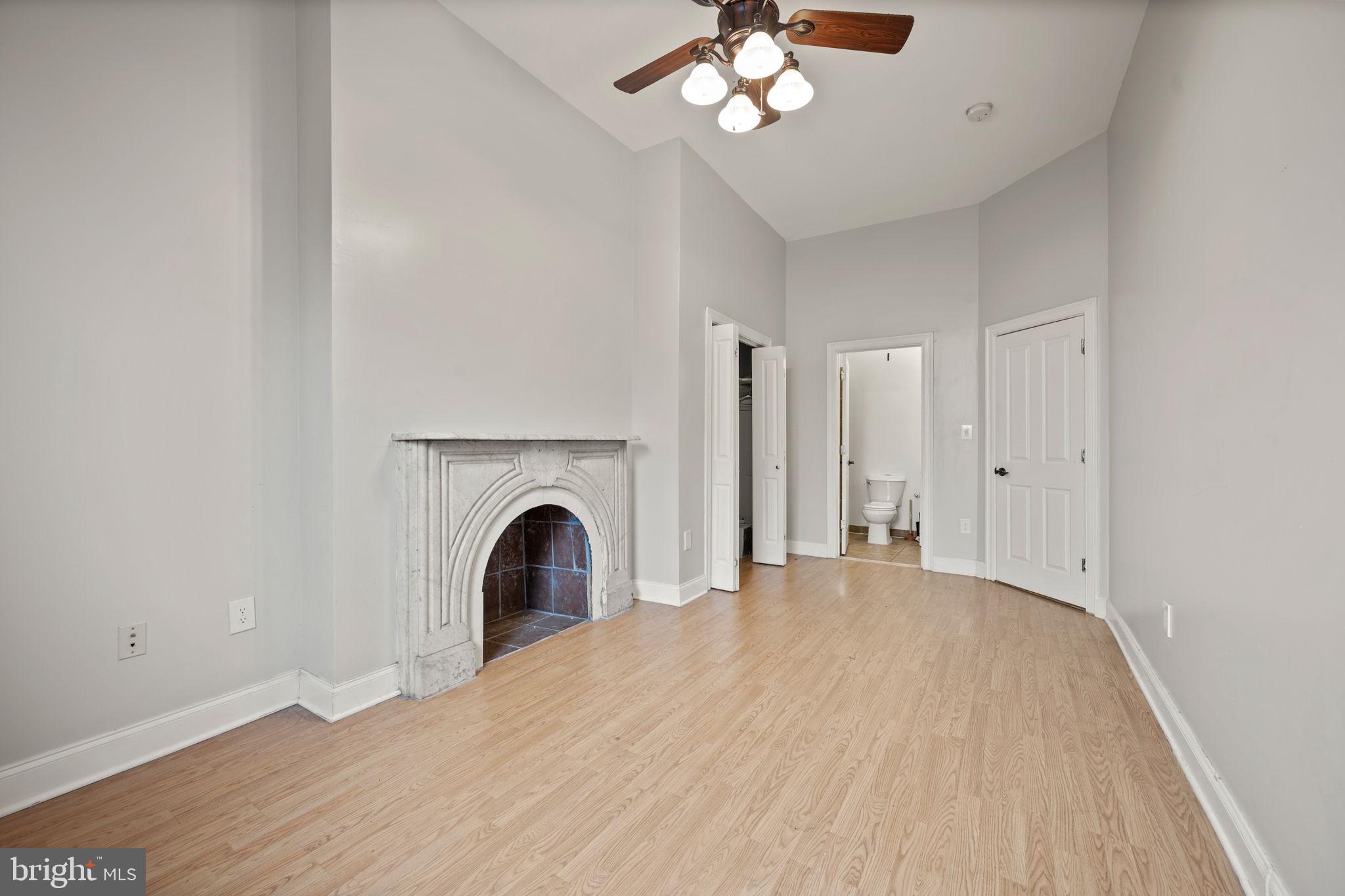 2422 Madison Avenue, Unit 1 Baltimore, MD 21217 - Photo 7 of 34 a view of an empty room with a fireplace