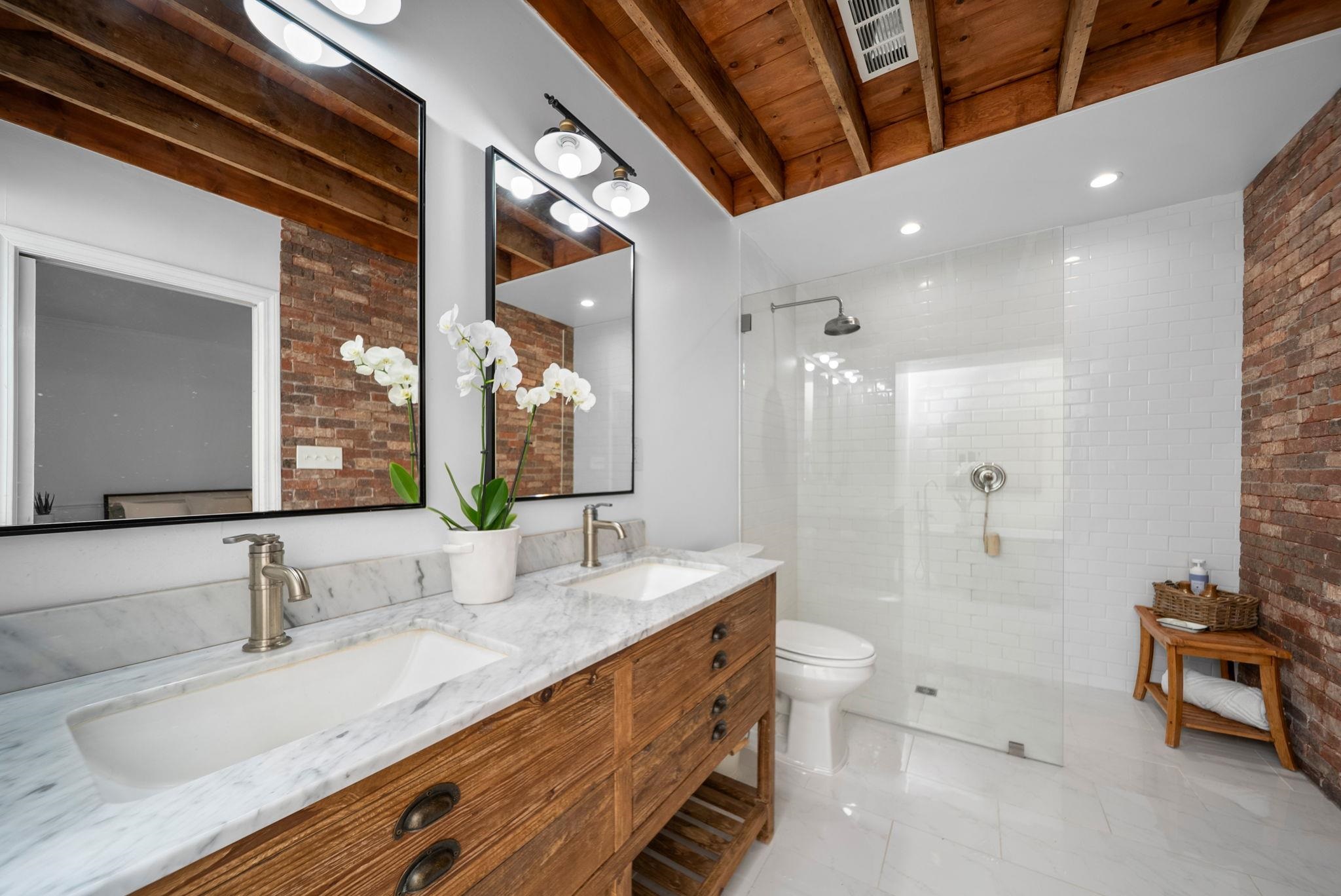 267 North Rose Road Memphis, TN 38117 - Photo 26 of 40 a spacious bathroom with a granite countertop sink a toilet a mirror and shower
