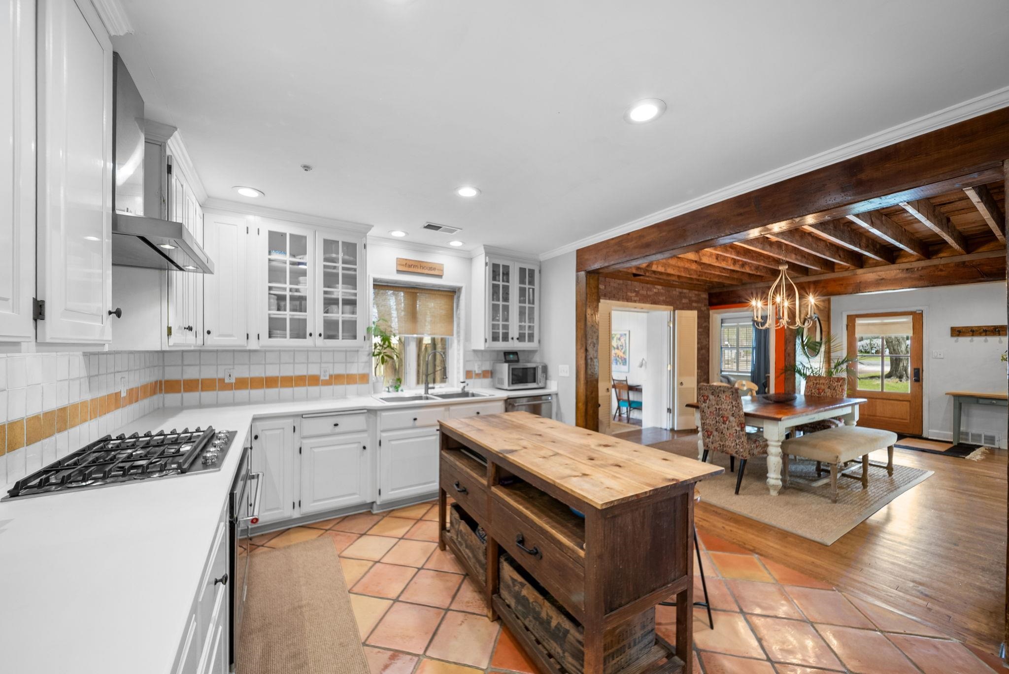 267 North Rose Road Memphis, TN 38117 - Photo 5 of 40 a kitchen with a stove a sink and a wooden cabinets