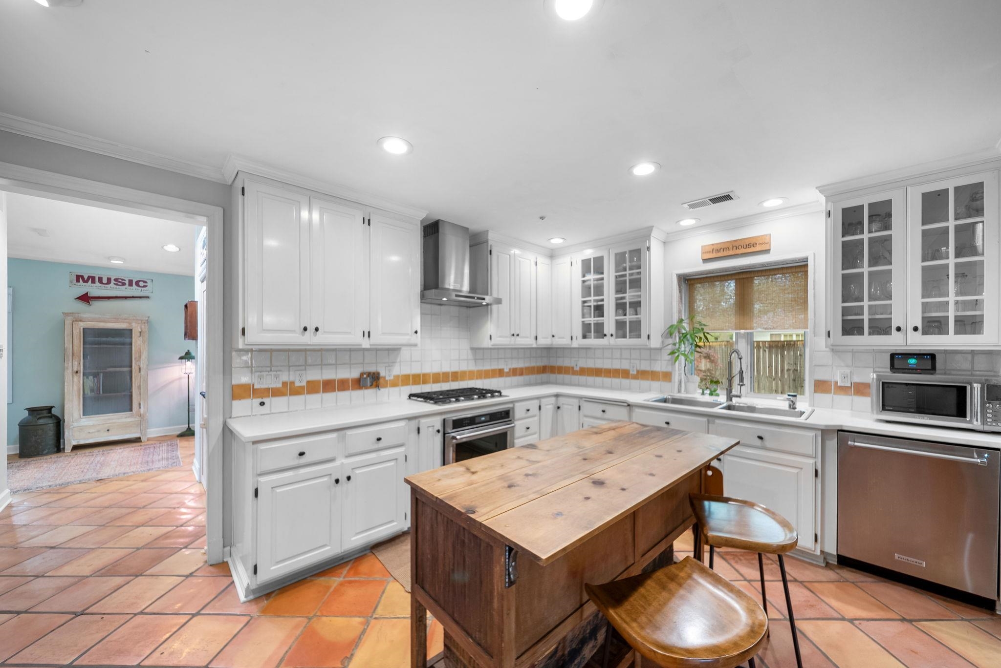 267 North Rose Road Memphis, TN 38117 - Photo 6 of 40 a kitchen with a stove a sink a refrigerator and cabinets
