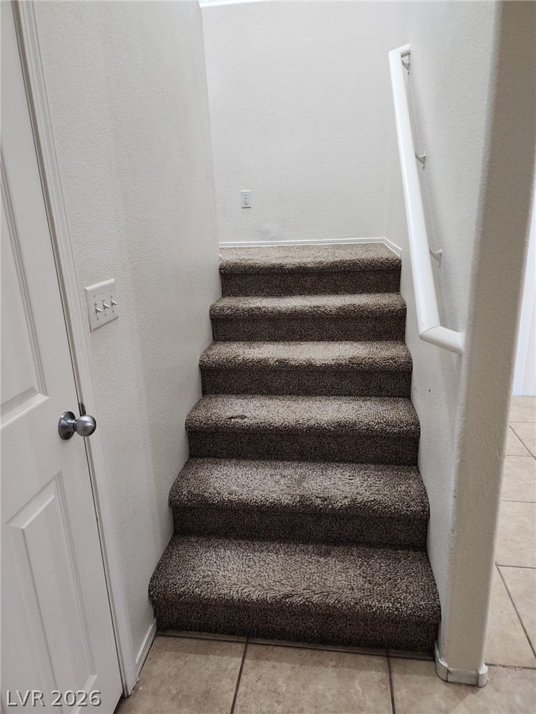 11901 Fairfax Ridge Street Las Vegas, NV 89183 - Photo 16 of 46 Stairway with tile patterned flooring and baseboards