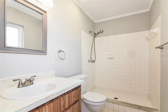 a bathroom with a sink toilet vanity and shower