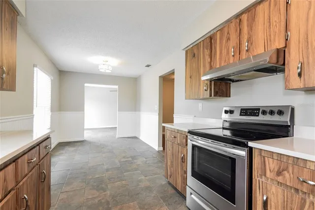 a kitchen with stainless steel appliances granite countertop a stove and a sink