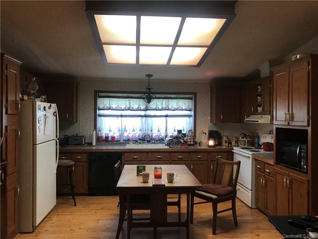 480 Hester Mill Road Rutherfordton, NC 28139 - Photo 23 of 38 a kitchen with a table chairs refrigerator and cabinets