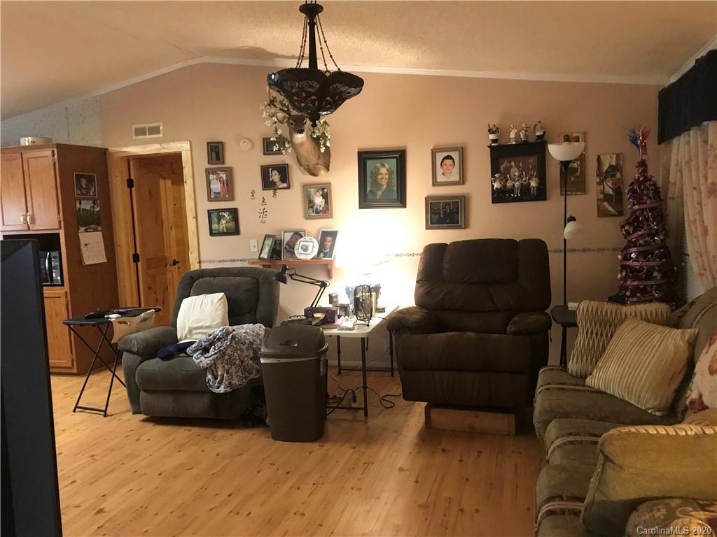 480 Hester Mill Road Rutherfordton, NC 28139 - Photo 27 of 38 a living room with furniture and a chandelier
