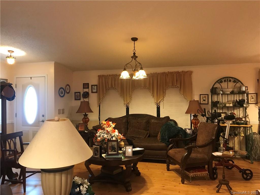 480 Hester Mill Road Rutherfordton, NC 28139 - Photo 31 of 38 a living room with furniture a chandelier and a mirror
