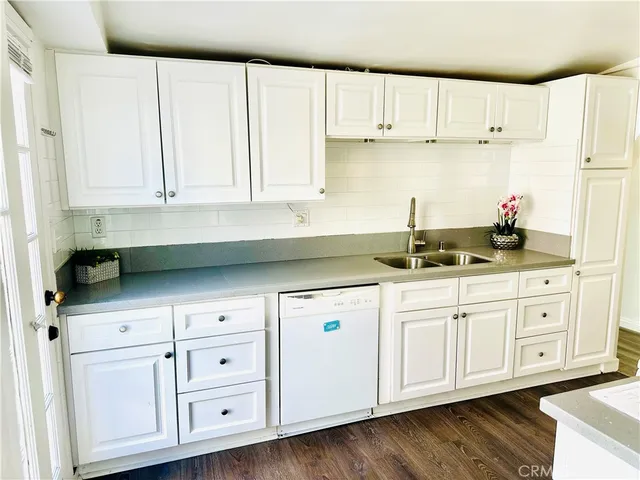 a kitchen with granite countertop white cabinets and white appliances