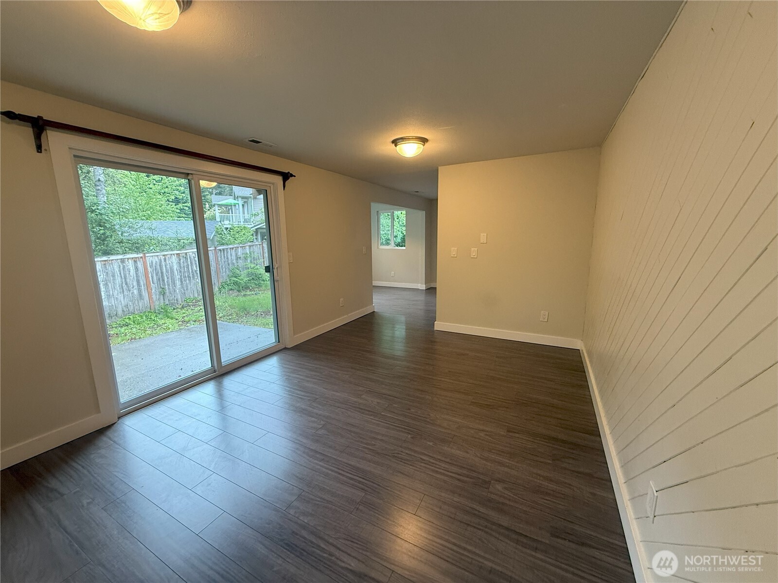 8820 Prentice Avenue Gig Harbor, WA 98332 - Photo 8 of 13 a view of an empty room with wooden floor and a window