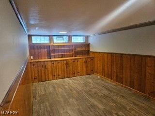 220 Greenvale Road Cleveland, OH 44121 - Photo 8 of 9 Empty room featuring wood walls, wood finished floors, and wainscoting