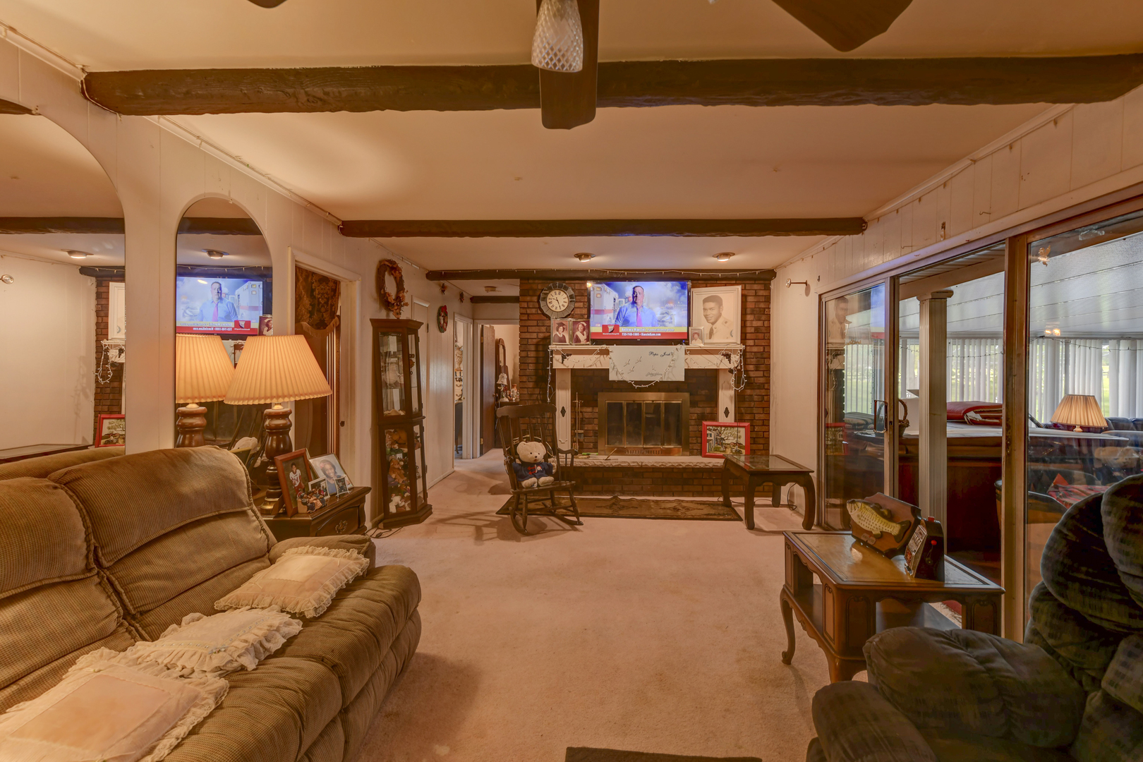 126 Denell Drive Crete, IL 60417 - Photo 22 of 30 a living room with furniture a flat screen tv and floor to ceiling window