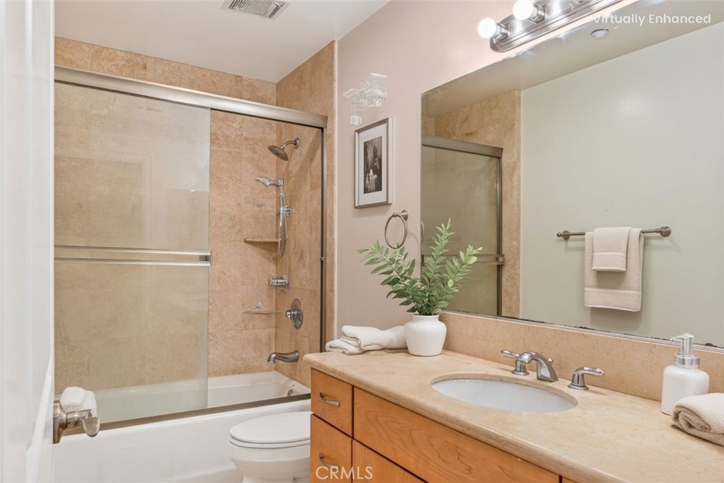 66 Allen Avenue, Unit 3 Pasadena, CA 91106 - Photo 24 of 25 a bathroom with a granite countertop sink toilet and shower