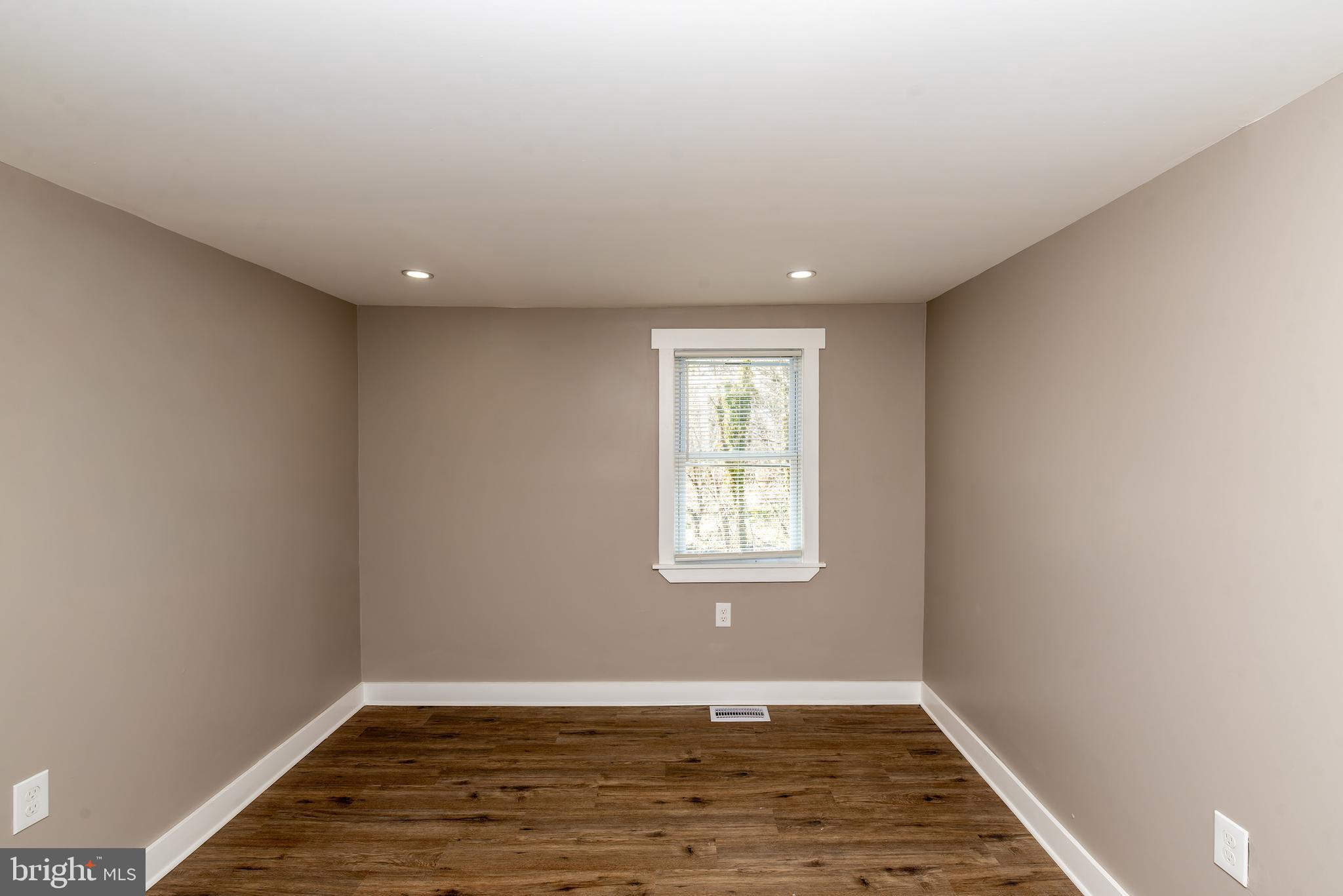 441 Harding Highway Pittsgrove, NJ 08318 - Photo 33 of 61 an empty room with wooden floor and windows