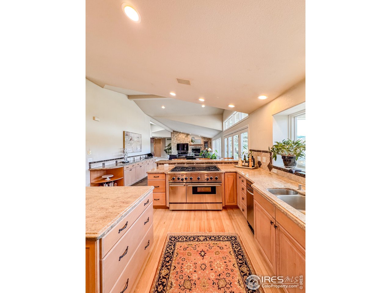 7155 Rustic Trail Boulder, CO 80301 - Photo 11 of 40 a large kitchen with stainless steel appliances granite countertop a sink and cabinets
