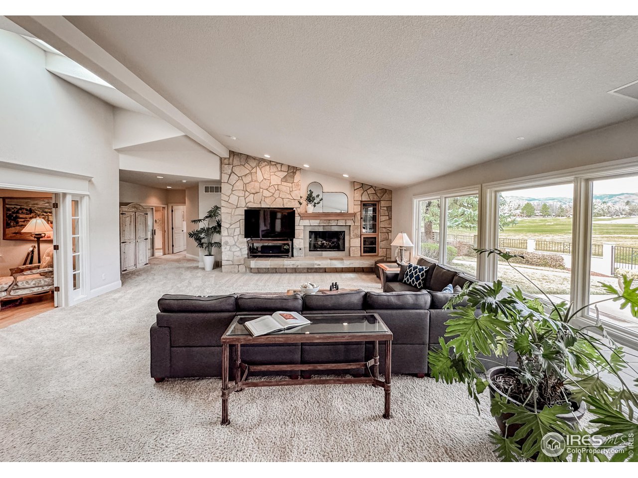 7155 Rustic Trail Boulder, CO 80301 - Photo 16 of 40 a living room with furniture and a flat screen tv