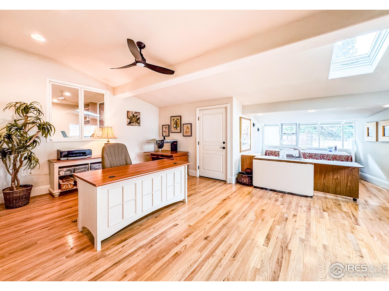 7155 Rustic Trail Boulder, CO 80301 - Photo 36 of 40 a large white kitchen with wooden floors