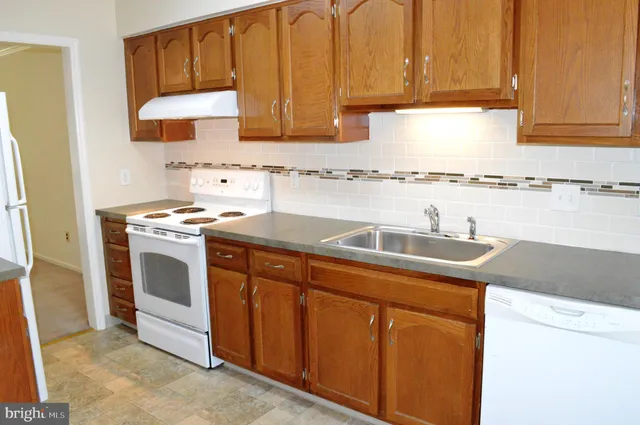 a view of a kitchen with a sink and a window