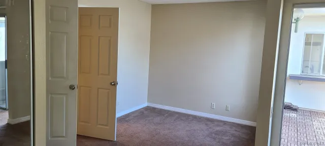 a view of a bathroom with a shower and a door